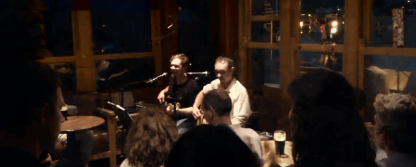 An audience gathered close around The Blow-Ins during an intimate performance in Dingle